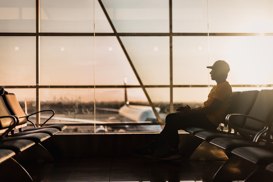 Traveler adjusting earbuds in airport terminal