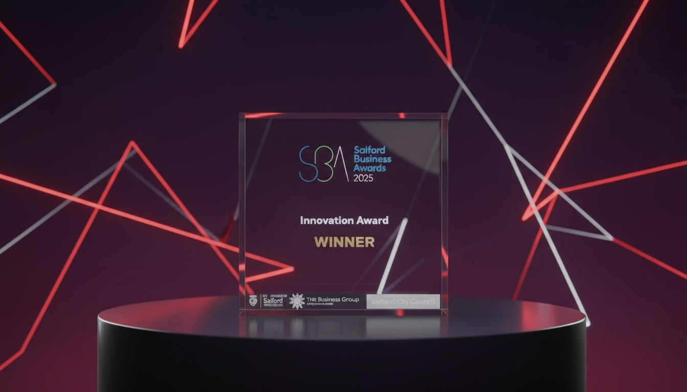 Salford Business Awards 2025 Innovation Award Winner trophy on display with red neon geometric background